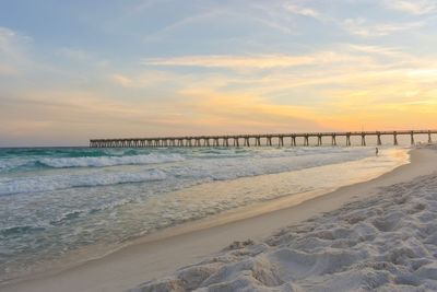 Scenic view of beach against sky during sunset