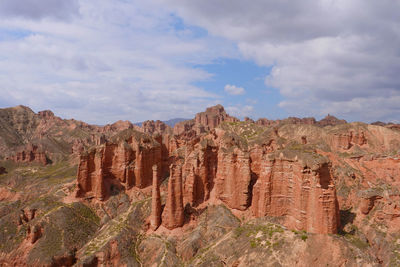 View of rock formations against cloudy sky