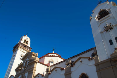 Low angle view of traditional building against clear blue sky