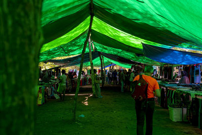 People at illuminated market stall