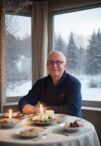 Portrait of man sitting on table