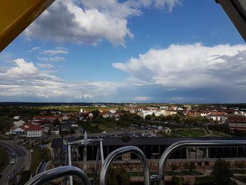 High angle view of arch bridge and buildings in city against sky