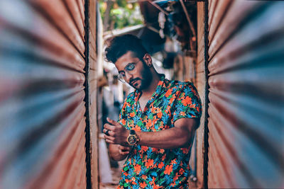 Young man standing in narrow alley