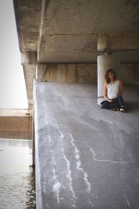 Full length of woman standing by railing