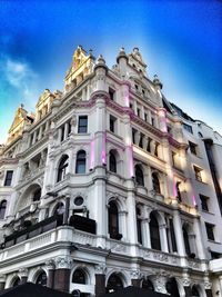 Low angle view of buildings against blue sky