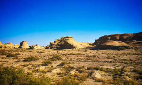 Rock formations against clear blue sky