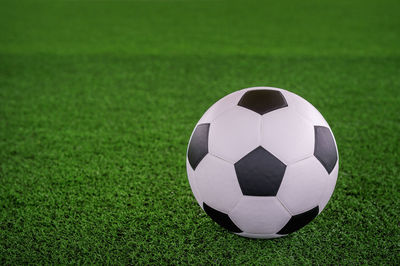 Digital composite of soccer ball on playing field