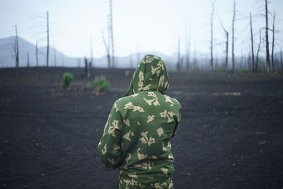 Rear view of woman standing on land