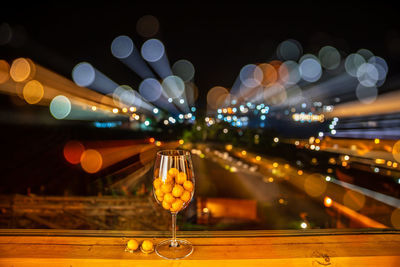 Defocused image of illuminated lights on table at night