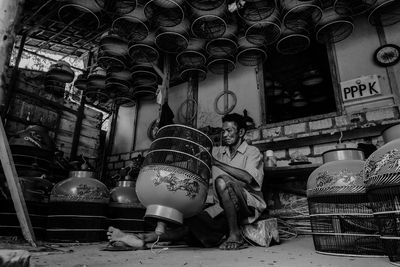 Low angle view of man making equipment in workshop