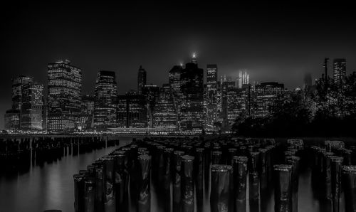 Illuminated buildings against sky at night