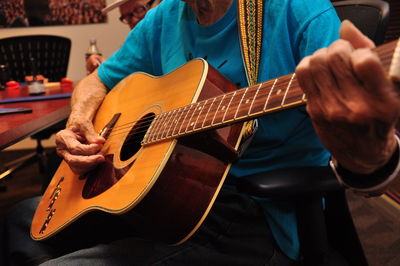 Close-up of man playing guitar