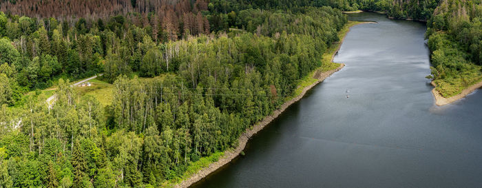 The river bode in the harz region of germany. two people on a zip line above the river.