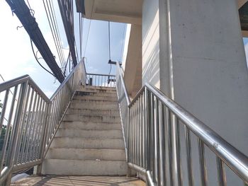 Low angle view of staircase by building against sky