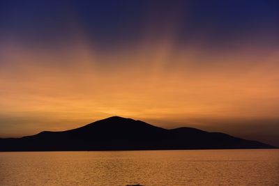 Scenic view of lake against orange sky