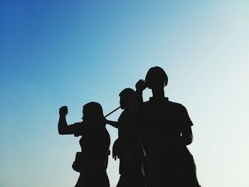 Low angle view of silhouette man against clear sky