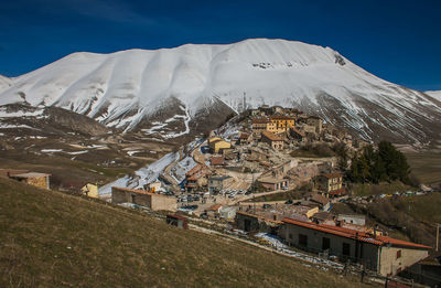 Aerial view of snowcapped mountain against sky