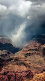 Scenic view of mountains against cloudy sky