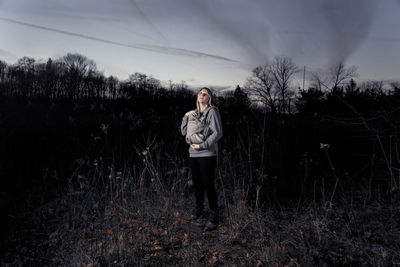 Full length of man standing on field against sky