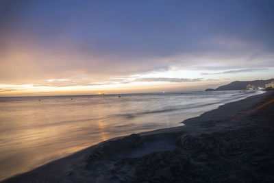 Scenic view of beach against sky during sunset