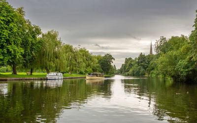 Idyllic scenic view down the river avon, with boats on the bank.