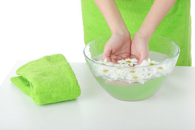 Midsection of woman having food against white background