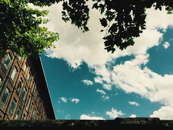 Low angle view of building against cloudy sky