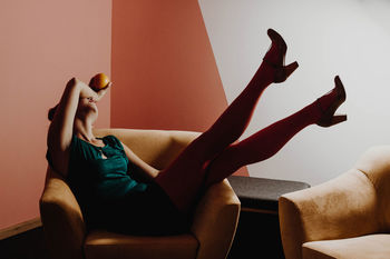 Woman relaxing on armchair at home