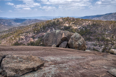 Rock formations on landscape against sky