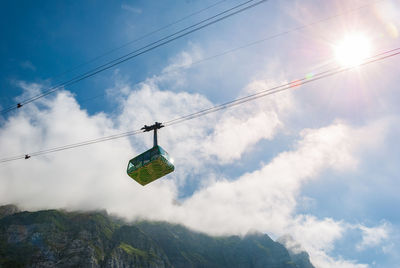 Low angle view of overhead cable cars against sky