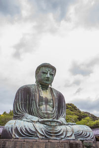 Statue of buddha against sky