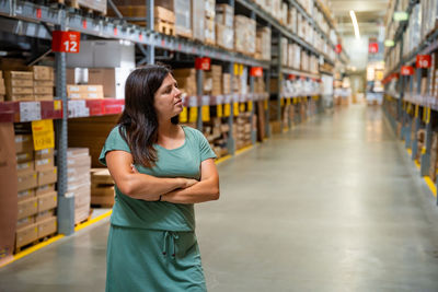 Portrait of young woman standing in supermarket