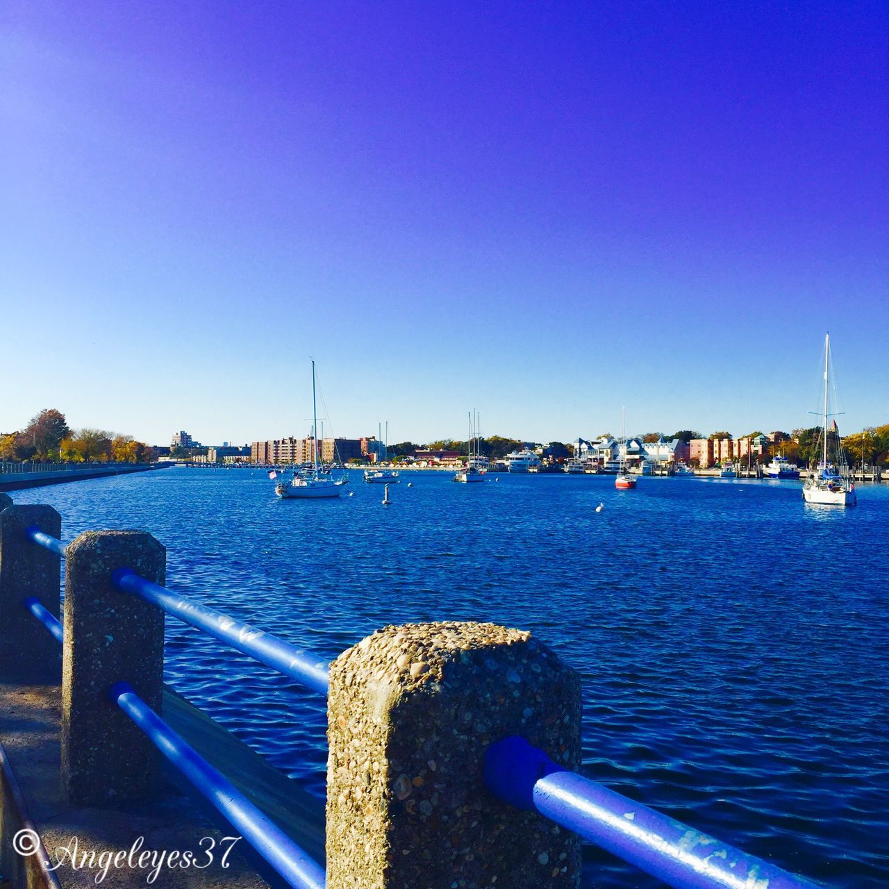 blue, water, clear sky, sea, nautical vessel, transportation, copy space, mode of transport, boat, harbor, built structure, pier, travel, architecture, moored, outdoors, tranquil scene, tranquility, travel destinations, rippled