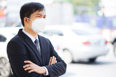 A business man wears a mask to protect corona virus before going to work at the office.