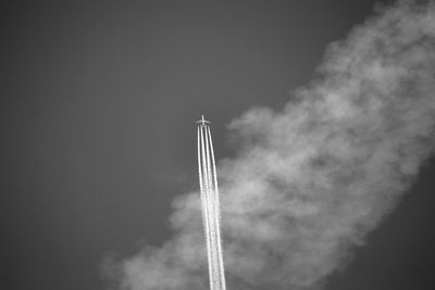 Low angle view of airplane flying against sky