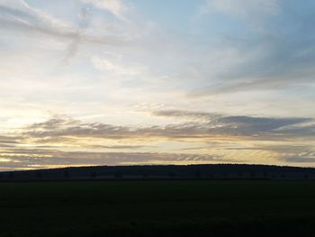 Scenic view of field against sky during sunset