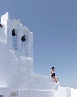 Low angle view of woman against clear sky