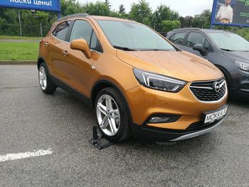 Close-up of yellow car on street