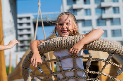 Low angle view of young woman looking away