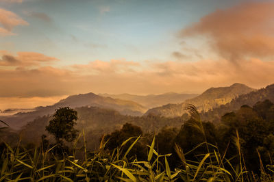Scenic view of mountains against sky at sunset