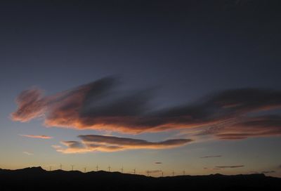 Low angle view of silhouette mountain against dramatic sky