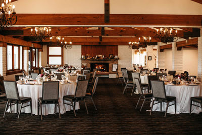 Beautiful wedding venue with white table cloths, glassware, floral arrangements center pieces 