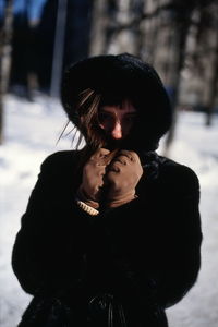 Midsection of woman standing in snow