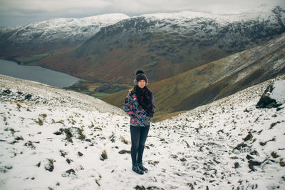 Woman skiing on snow covered landscape