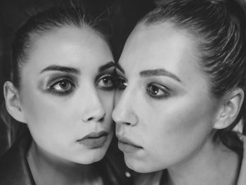 Close-up of serious woman by mirror