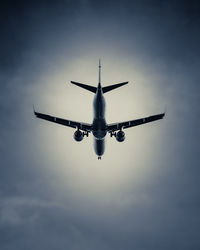 Low angle view of airplane flying in sky