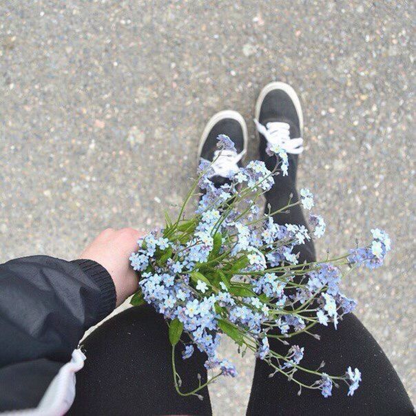 low section, personal perspective, shoe, person, high angle view, lifestyles, footwear, standing, leisure activity, men, human foot, unrecognizable person, part of, directly above, street, flower, day