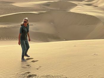 Full length of man standing on sand at beach