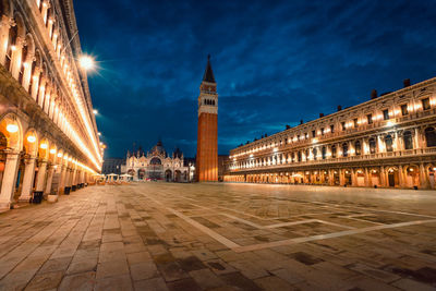 View of st. mark's square with its famous cathedral and bell tower with illuminated buildings