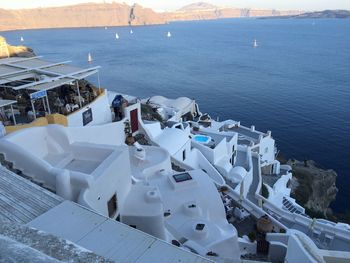 High angle view of buildings by sea against sky